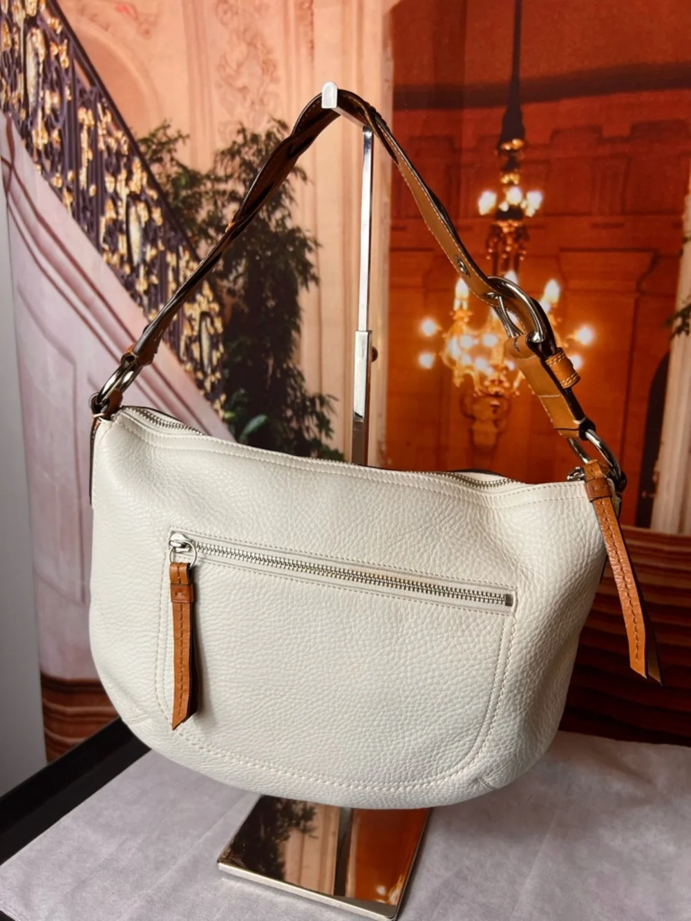 Coach Soho White Pebbled Leather Hobo bag features a distinctive braided handle